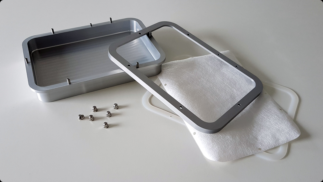 Disassembled Lyoprotect Aluminum Tray with gasket, membrane, fixing frame and acorn nuts